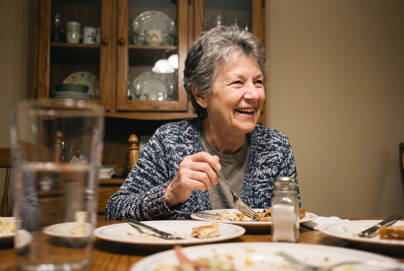 Her mom, caught in a small laugh at the table